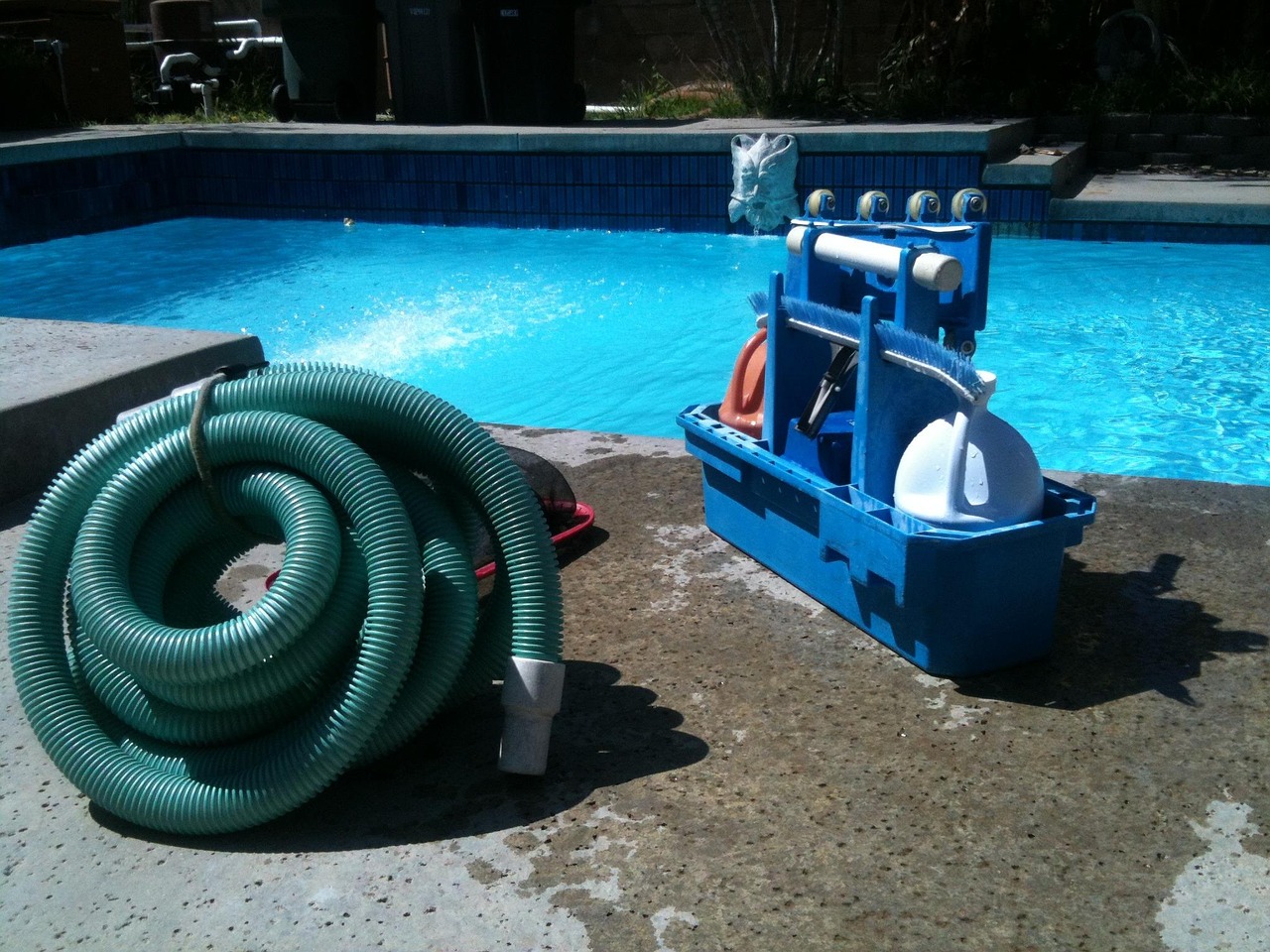 Pool service equipment and cleaning tools at poolside